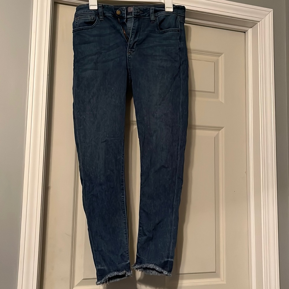 Medium wash straight leg jeans with frayed cuffs
